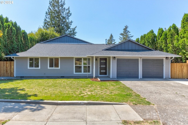 ranch-style home featuring a garage and a front yard