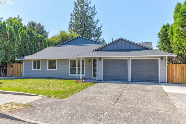 ranch-style home with a front lawn and a garage