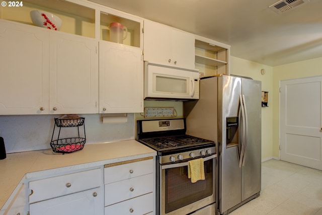 kitchen featuring appliances with stainless steel finishes and white cabinets