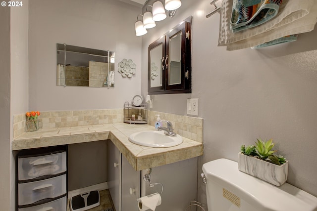 bathroom featuring decorative backsplash, sink, and toilet