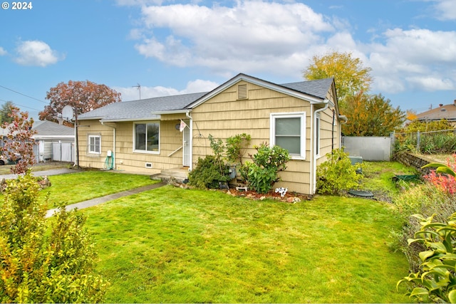 rear view of property featuring a yard