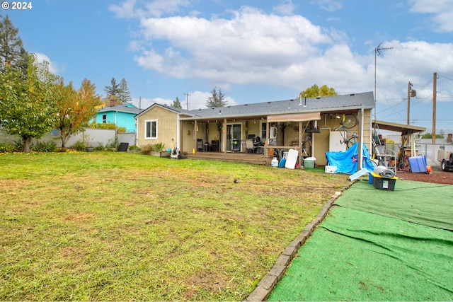 rear view of property featuring a patio and a yard