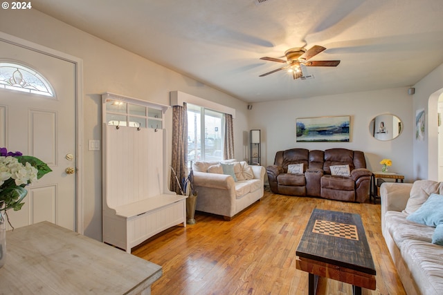 living room featuring plenty of natural light, ceiling fan, and light hardwood / wood-style flooring