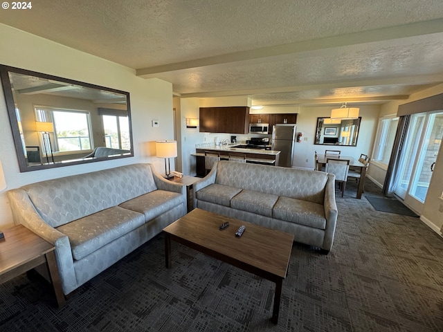 carpeted living room with beam ceiling and a textured ceiling