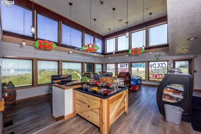 playroom with a towering ceiling and dark hardwood / wood-style floors