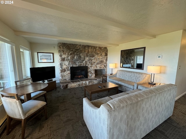 living room featuring dark carpet, a textured ceiling, beamed ceiling, and a fireplace