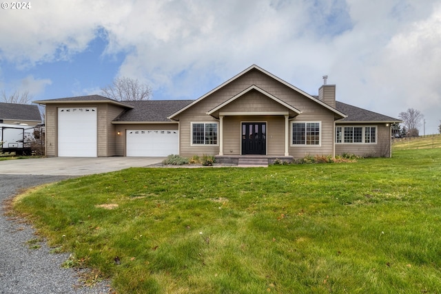 view of front facade with a garage and a front lawn