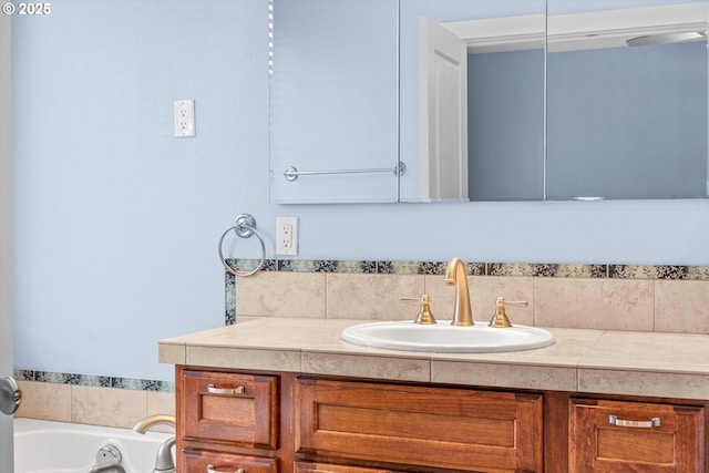 bathroom featuring vanity and a garden tub