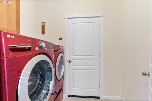 laundry room featuring cabinet space, independent washer and dryer, and baseboards