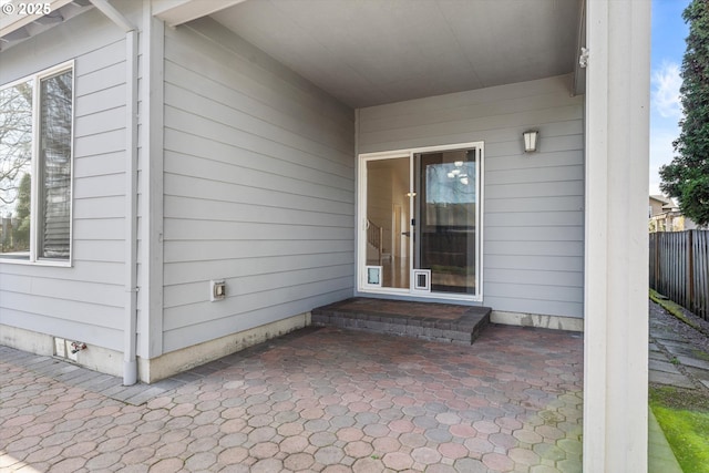 doorway to property featuring a patio area and fence