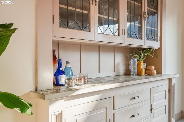 bar featuring white cabinetry