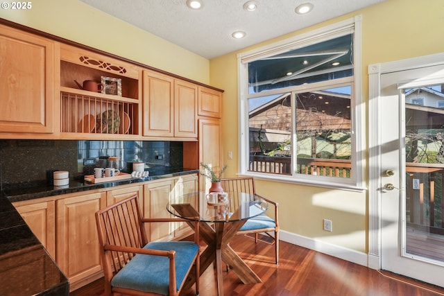 kitchen with a textured ceiling, backsplash, dark hardwood / wood-style floors, and light brown cabinets