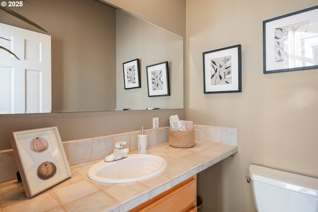 bathroom with toilet and vanity