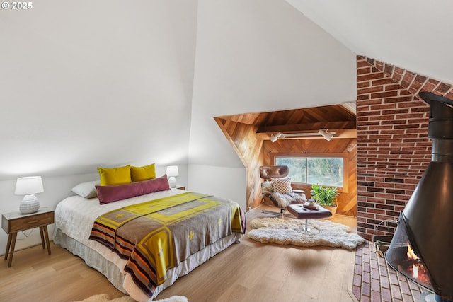 bedroom featuring light wood-type flooring and vaulted ceiling