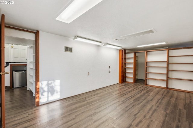 interior space featuring a textured ceiling and hardwood / wood-style floors