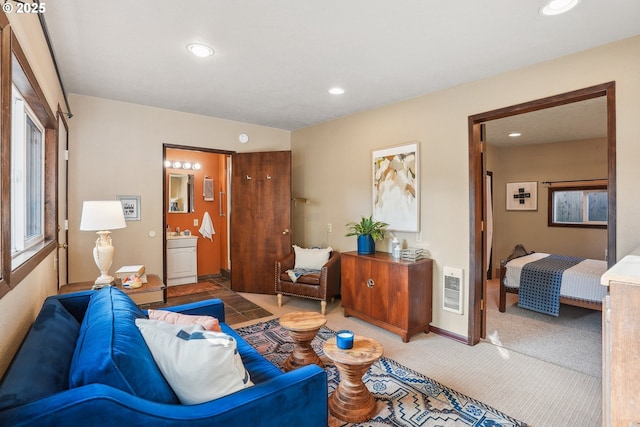 carpeted living room featuring heating unit