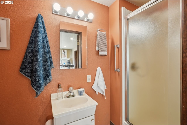 bathroom featuring an enclosed shower and vanity