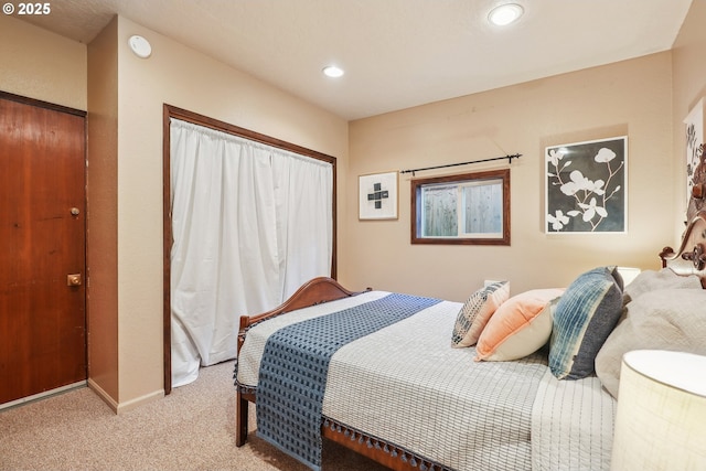 bedroom with light colored carpet and a closet