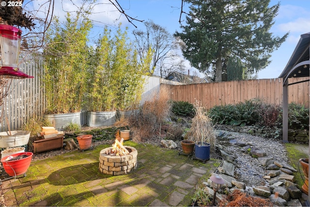 view of yard with a patio area and a fire pit