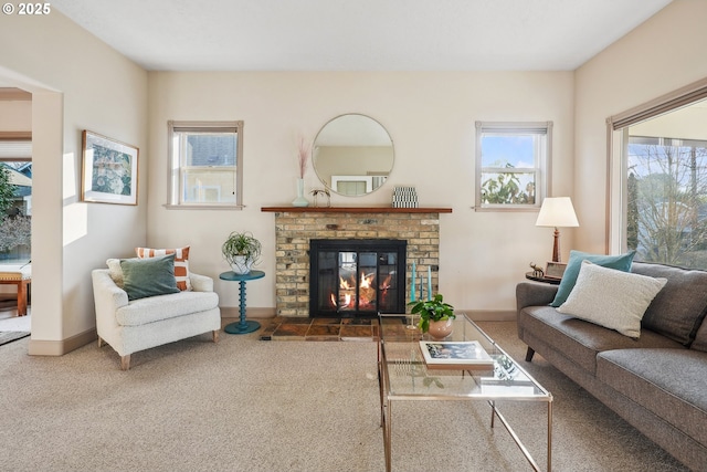 living room with a brick fireplace and dark colored carpet