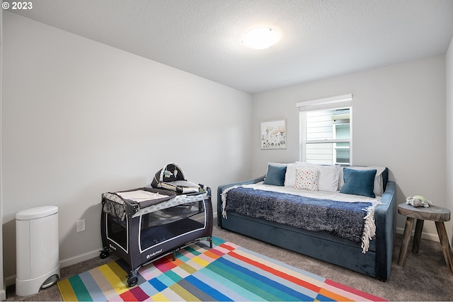 carpeted bedroom with a textured ceiling