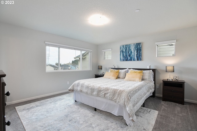 bedroom featuring a textured ceiling and carpet flooring