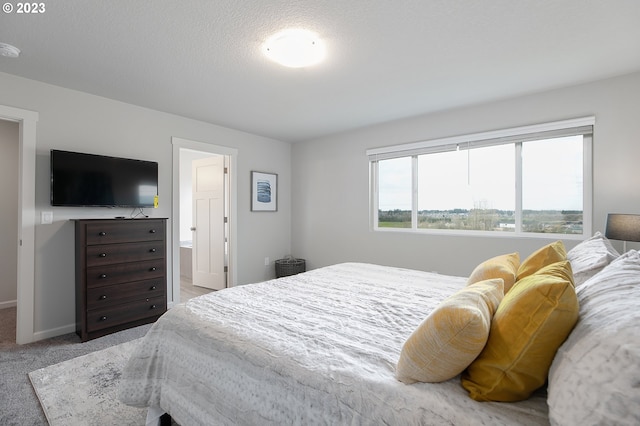 carpeted bedroom featuring connected bathroom