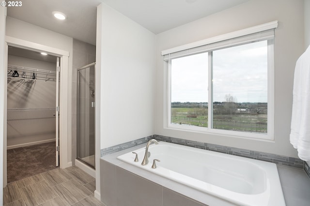 bathroom featuring independent shower and bath