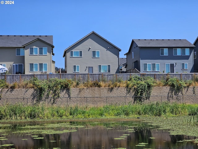 rear view of property with a water view