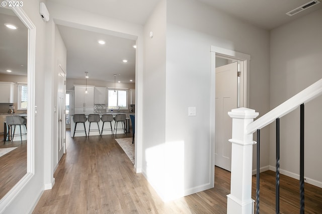 corridor featuring light hardwood / wood-style floors