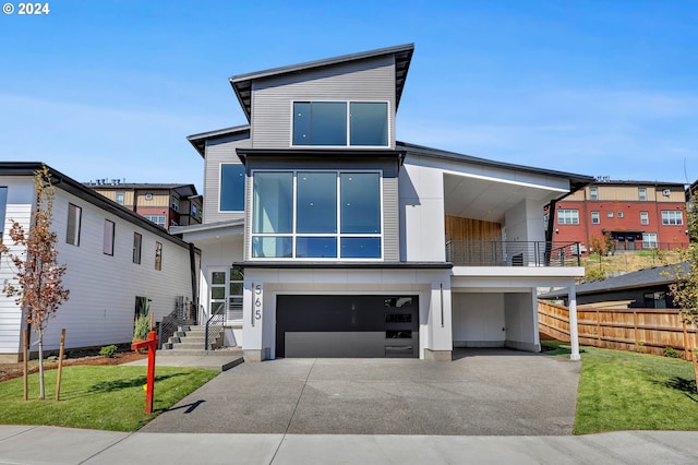 modern home featuring a garage and a front lawn