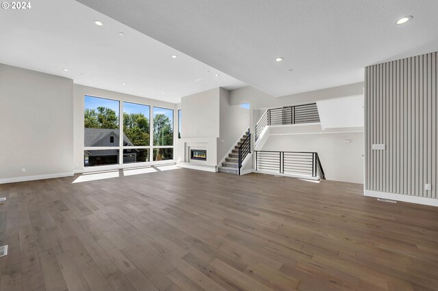 unfurnished living room with dark hardwood / wood-style floors