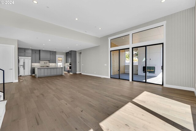 unfurnished living room featuring hardwood / wood-style flooring