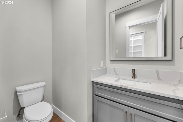 bathroom featuring toilet and vanity