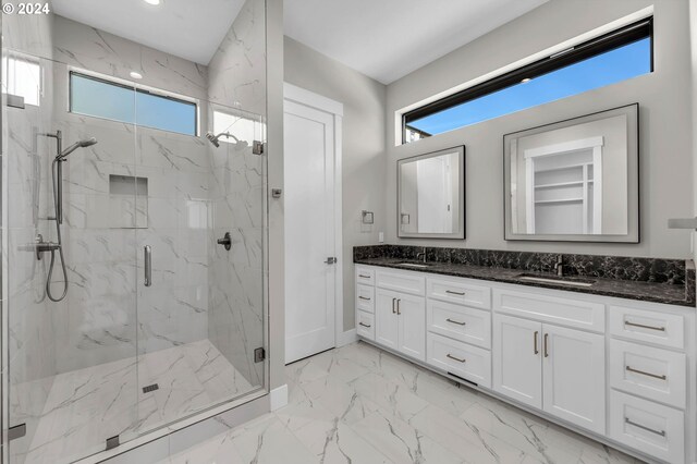 bathroom featuring vanity and a shower with shower door