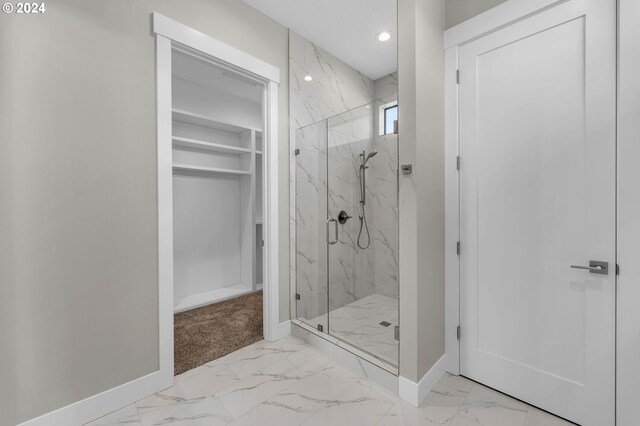 bathroom featuring a shower with door