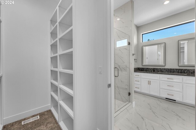 bathroom with walk in shower and vanity