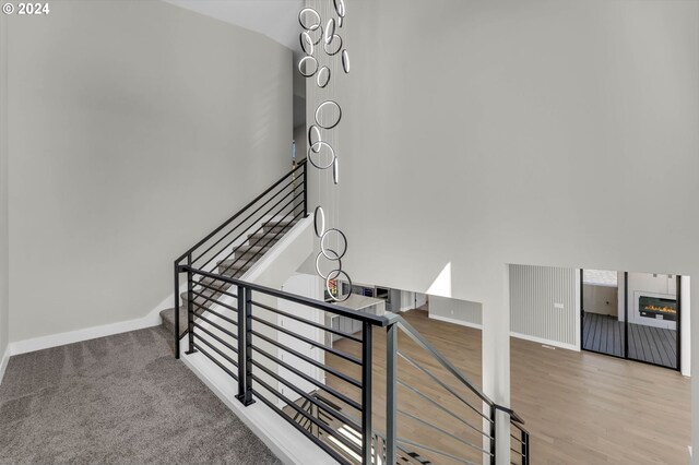 stairs featuring lofted ceiling and wood-type flooring