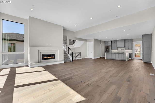 unfurnished living room with hardwood / wood-style floors