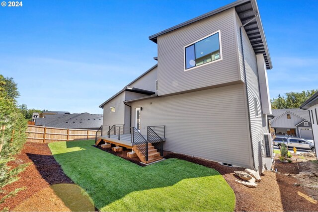 rear view of house featuring a lawn