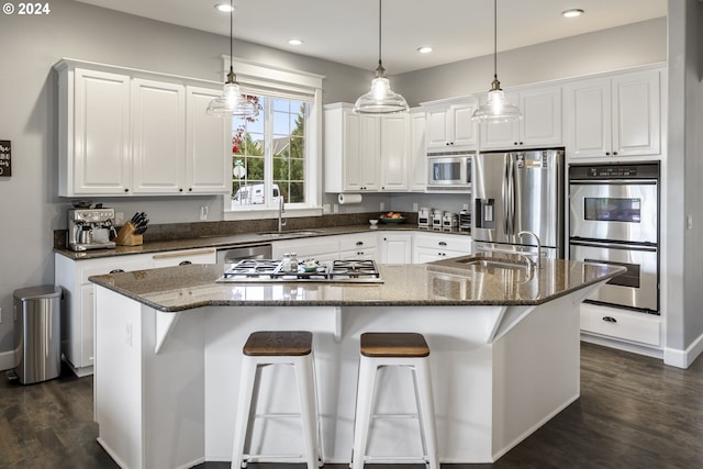 kitchen featuring dark stone countertops, white cabinetry, sink, and appliances with stainless steel finishes