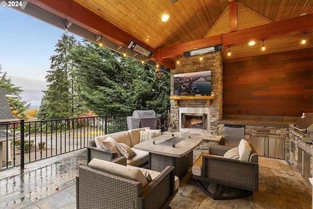 patio terrace at dusk with an outdoor living space with a fireplace and area for grilling