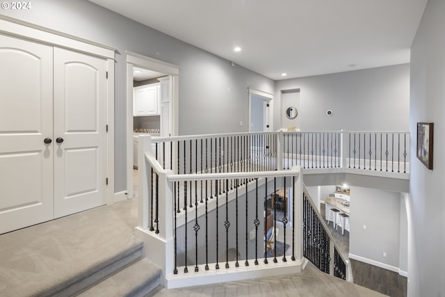 hall with light colored carpet