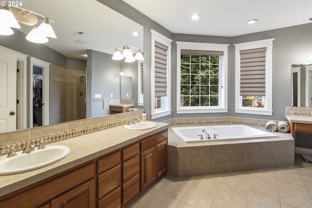 bathroom with tile patterned flooring, vanity, and shower with separate bathtub