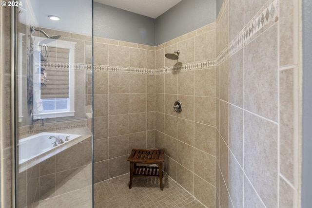 bathroom featuring independent shower and bath