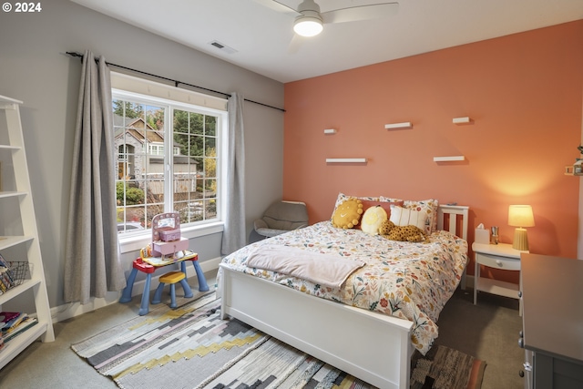 bedroom featuring dark colored carpet and ceiling fan