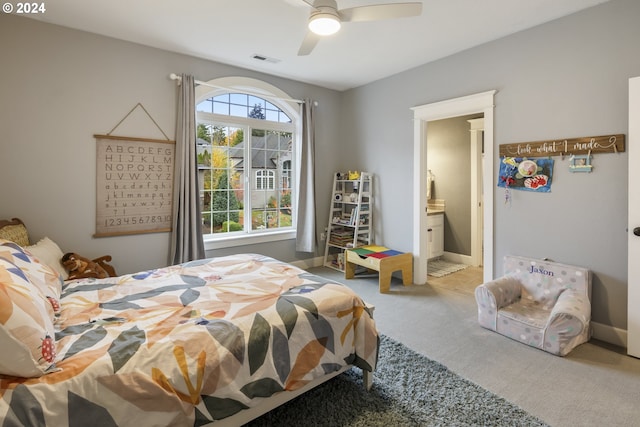 bedroom featuring carpet, ensuite bathroom, and ceiling fan