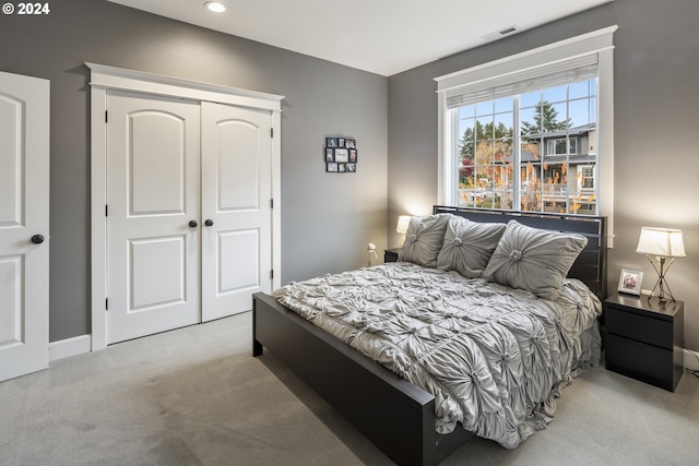 carpeted bedroom featuring a closet