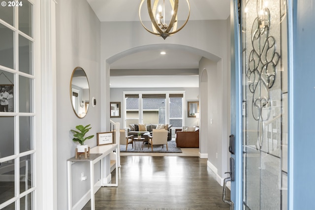 foyer entrance featuring french doors, dark hardwood / wood-style flooring, and an inviting chandelier