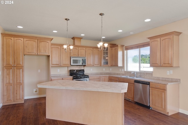 kitchen with appliances with stainless steel finishes, hanging light fixtures, a center island, dark hardwood / wood-style flooring, and sink